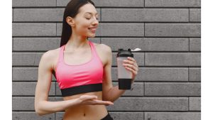 woman-practicing-advanced-yoga-against-dark-urban-wall.j